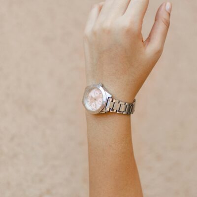 Close-up shot of a woman's hand wearing an elegant wristwatch, showcasing minimalist design and style.