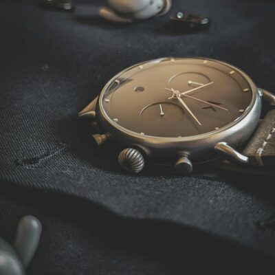 Photo by Obi Onyeador Stylish wristwatch lying on a dark fabric, emphasizing luxury and elegance.